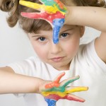Child coloured paint on hands
